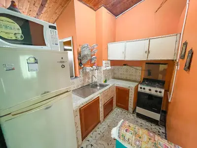 a kitchen with a white refrigerator and a sink at Casa Los Patios in Jericó