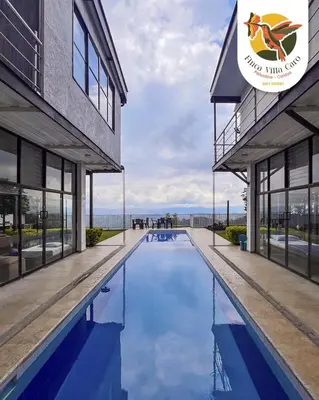 a swimming pool in front of a building at VILLA CARO in Palestina