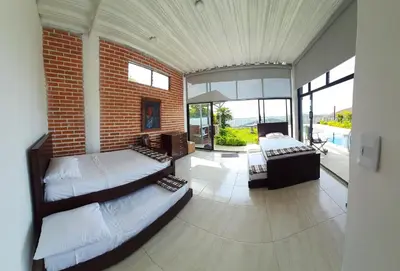 a bedroom with two beds and a brick wall at VILLA CARO in Palestina