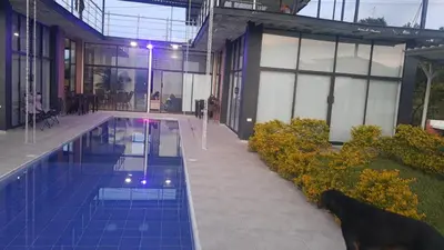 a large building with a swimming pool in front of it at VILLA CARO in Palestina