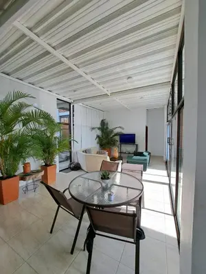 a living room with a glass table and chairs at VILLA CARO in Palestina