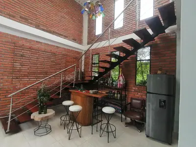 a room with a bar and a brick wall at VILLA CARO in Palestina