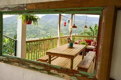 a room with a table and a view of the mountains at Casa La Martina disponible en Jardín Antioquia in Jardin