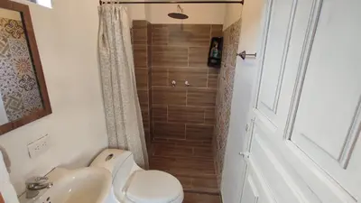 a bathroom with a shower and a toilet and a sink at Casa La Martina disponible en Jardín Antioquia in Jardin