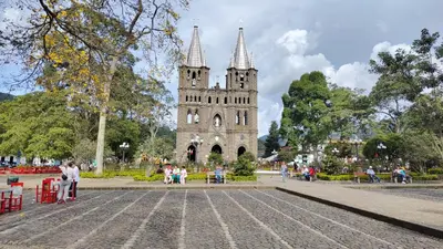 a building with a clock tower in a park at Casa La Martina disponible en Jardín Antioquia in Jardin
