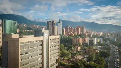 a view of a city with a tall building at Apartamentos Go Living & Suites by HOUSY in Medellín