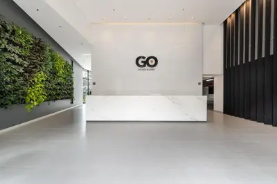 a lobby with a go sign on the wall at Apartamentos Go Living & Suites by HOUSY in Medellín