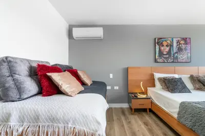 a bedroom with two beds with red pillows at Apartamentos Go Living & Suites by HOUSY in Medellín