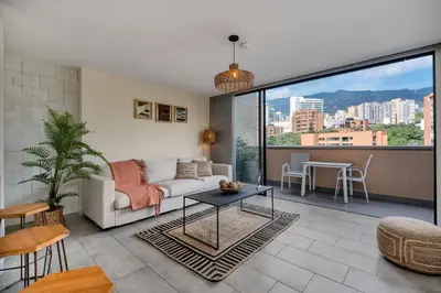 a living room with a couch and a table at Apartamentos Go Living & Suites by HOUSY in Medellín