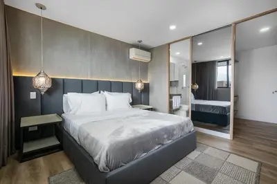 a bedroom with a large bed and a large mirror at Apartamentos Go Living & Suites by HOUSY in Medellín