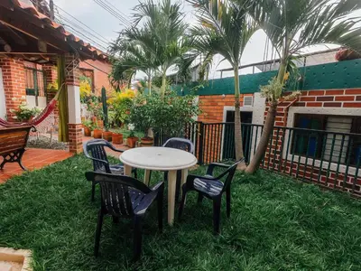a table and chairs on the grass in a yard at KasaGrande in Santa Fe de Antioquia