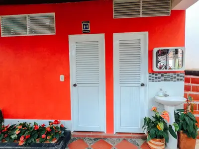 a red building with a sink and a red wall at KasaGrande in Santa Fe de Antioquia