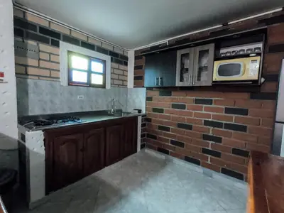 a kitchen with a stove and a microwave at KasaGrande in Santa Fe de Antioquia