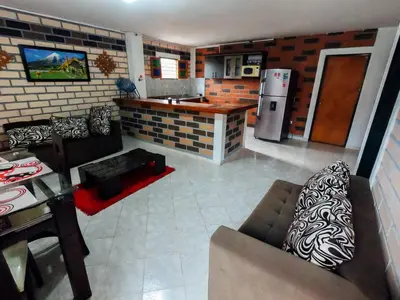 a kitchen and living room with a couch and a table at KasaGrande in Santa Fe de Antioquia