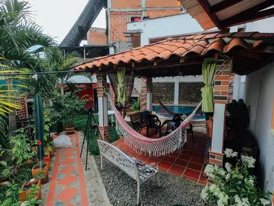 a patio with a hammock under a house at KasaGrande in Santa Fe de Antioquia