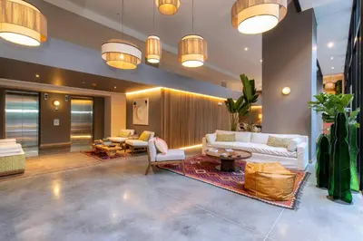 a living room with a couch and chairs and lights at Landmark Hotel in Medellín