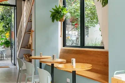 a couple of tables in a room with windows at Landmark Hotel in Medellín