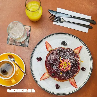 a plate with a pancake in the shape of a face at Landmark Hotel in Medellín