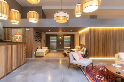 a living room with chairs and tables and lights at Landmark Hotel in Medellín