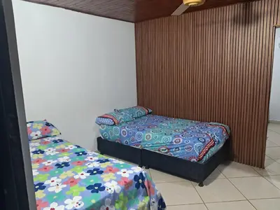 a bedroom with two beds in a room at Casa Puerto Triunfo Dann in Puerto Triunfo