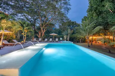 a swimming pool in a resort at night at Casa Jacaranda Hotel Boutique -Cauca Viejo- Mayores de 14 años in Jericó