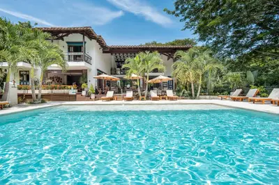 a large swimming pool in front of a house at Casa Jacaranda Hotel Boutique -Cauca Viejo- Mayores de 14 años in Jericó