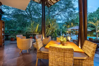 an outdoor dining room with a table and chairs at Casa Jacaranda Hotel Boutique -Cauca Viejo- Mayores de 14 años in Jericó