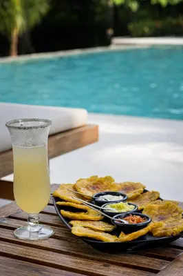 a plate of food and a drink on a table at Casa Jacaranda Hotel Boutique -Cauca Viejo- Mayores de 14 años in Jericó
