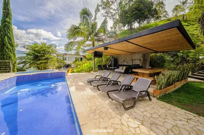 a patio with chairs and a swimming pool at Cabañas de Lujo en Medio de la Naturaleza in Don Matías