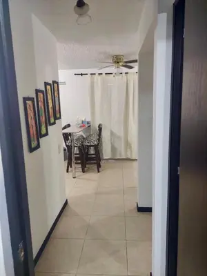 a hallway with a table and a ceiling fan at Apartasol Ciudadela Santa Fé in Santa Fe de Antioquia