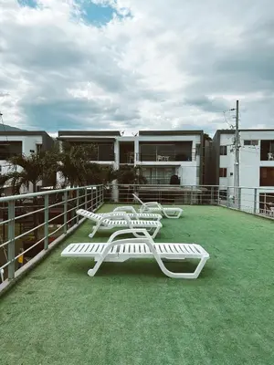 two white benches on the roof of a building at Apartasol Ciudadela Santa Fé in Santa Fe de Antioquia