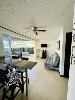 a living room with a table and a couch at Apartasol Ciudadela Santa Fé in Santa Fe de Antioquia