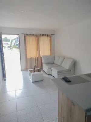 a living room with a couch and a table at Apartamento acogedor para vacacionar o de trabajo in Rionegro