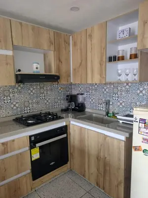 a kitchen with a sink and a stove top oven at Apartamento acogedor para vacacionar o de trabajo in Rionegro