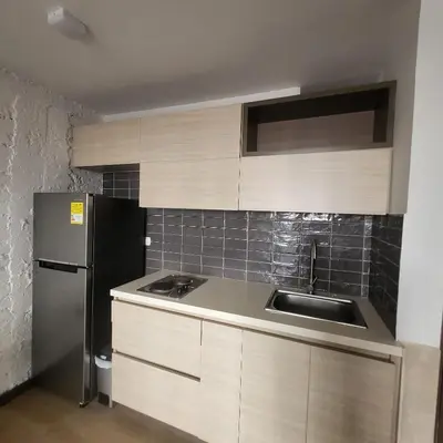 a kitchen with a sink and a refrigerator at Casa Azul - Apartamentos Amoblados - in Manizales