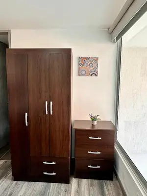 a bedroom with a wooden cabinet and a dresser at Apartamentos cómodos en Milan zona G in Manizales