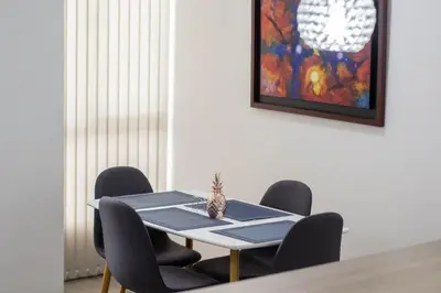 a dining room table with chairs and a pineapple on it at Apartamentos cómodos en Milan zona G in Manizales