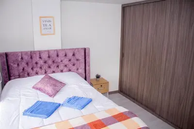 a bedroom with a bed with two pillows on it at Apartamentos cómodos en Milan zona G in Manizales