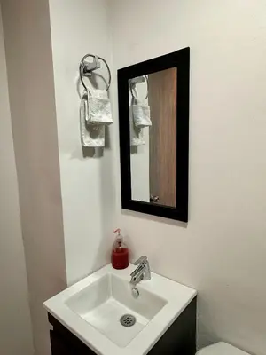 a bathroom with a white sink and a mirror at Apartamentos cómodos en Milan zona G in Manizales