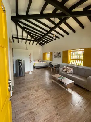 a living room with a couch and a table at Palmar de Jericó Suites in Jericó
