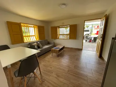 a living room with a couch and a table at Palmar de Jericó Suites in Jericó