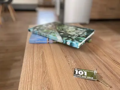a book sitting on top of a table with a pair of scissors at Palmar de Jericó Suites in Jericó
