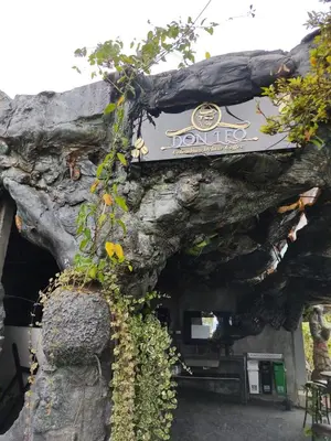 a sign on the side of a stone building at Glamping Spa & Coffee Tour in Medellín