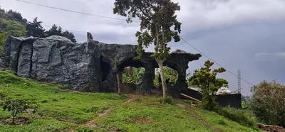 an old stone building on a hill with a tree at Glamping Spa & Coffee Tour in Medellín
