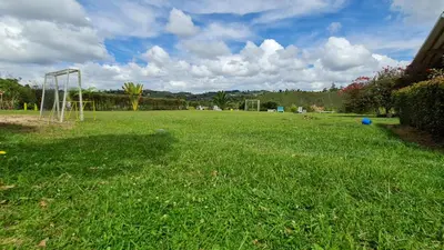 a large grassy field with a soccer goal at HOSTERÍA BRISAS DEL RÍO in Marinilla