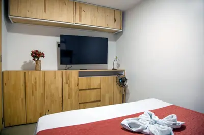 a room with a bed with a tv and a bed sidx sidx sidx at Edificio Helena in Medellín