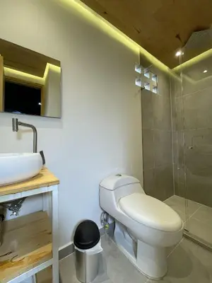 a bathroom with a toilet and a sink and a shower at Edificio Helena in Medellín