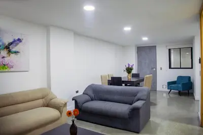 a living room with a couch and a chair at Edificio Helena in Medellín