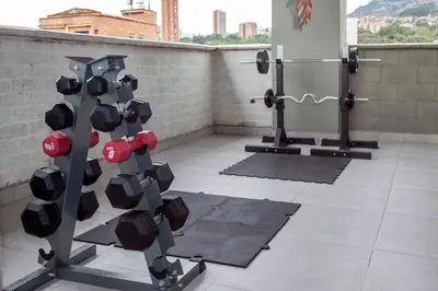 a gym with a bunch of equipment in a room at Edificio Helena in Medellín