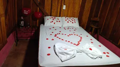a bed with a heart made out of red hearts at Finca Cafetera el Coral in Jardin